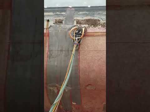 Robot removing OB and ship side coating using water