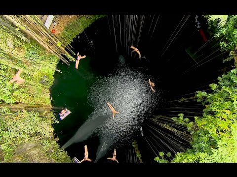 Group Cliff Dive into the Ik Kil Cenote