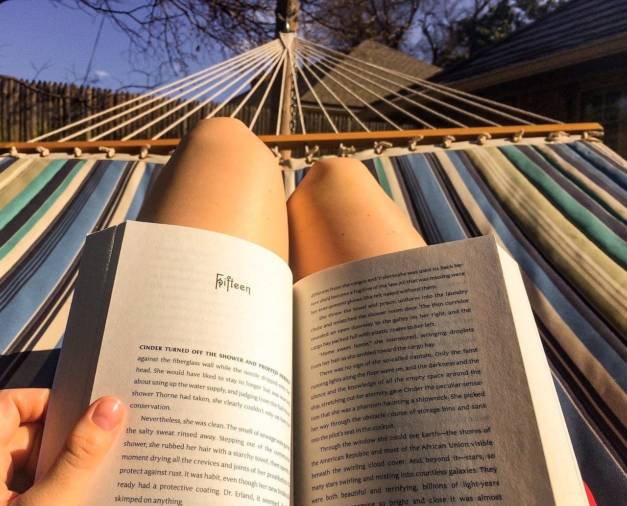 A person enjoying the smell of a book
