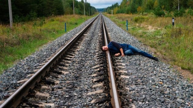 Person standing near train tracks
