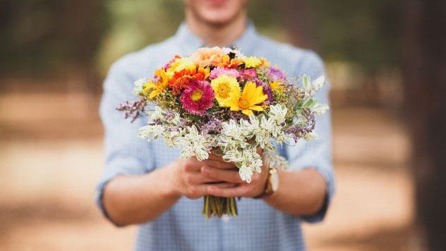 man holding flowers