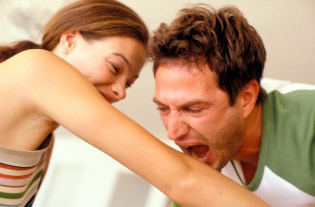 A person being bitten on the arm