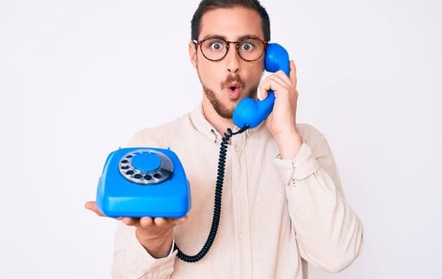 A person talking on a vintage phone