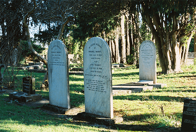 Artistic and historic tombstones in a serene cemetery setting