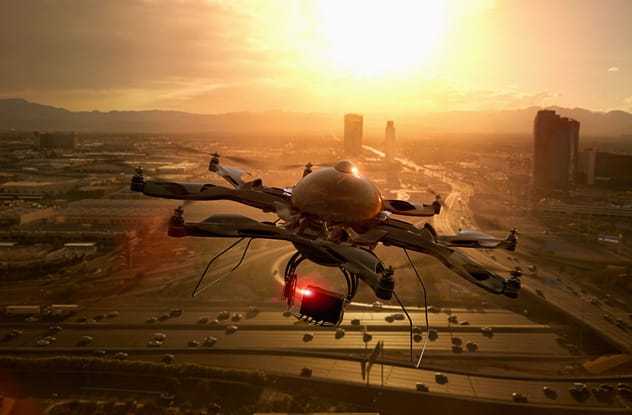 A surveillance drone flying against a cloudy sky