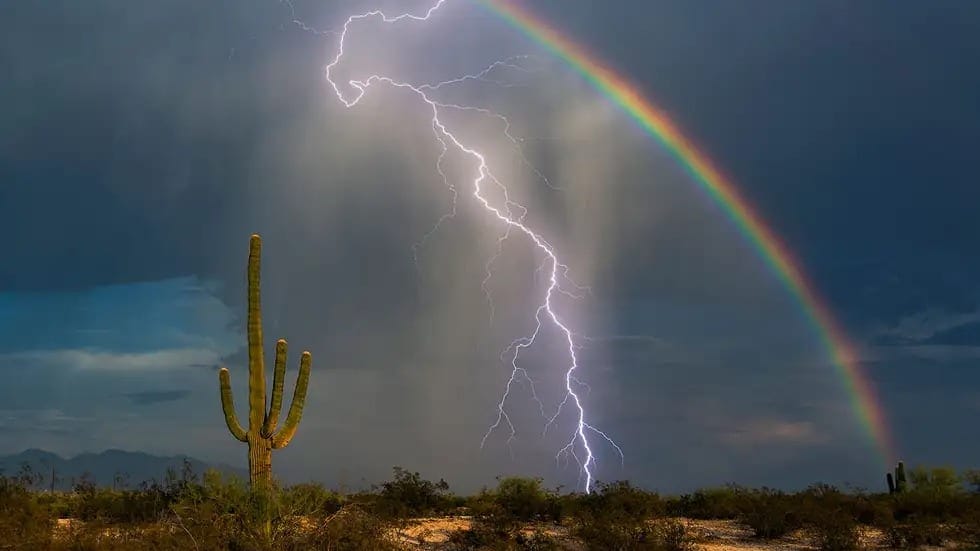 Rainbow with lightning in front