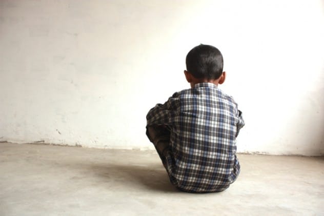 Sad child sitting alone