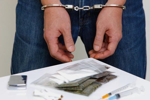 Law enforcement officer apprehending a suspected drug dealer