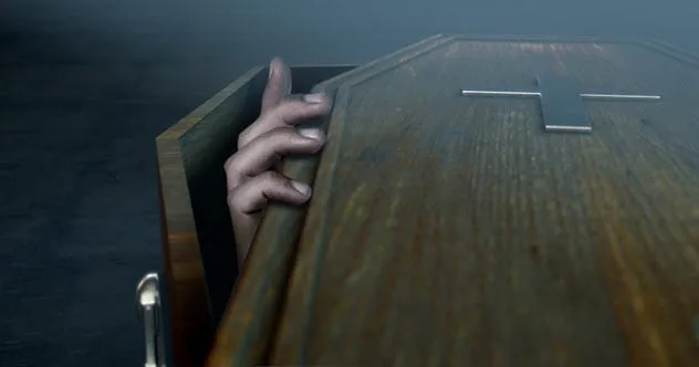 hand reaching out of coffin