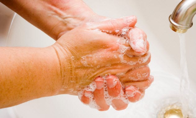 Person repeatedly washing their hands, symbolizing OCD