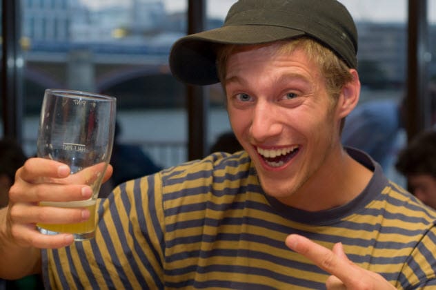 Joyful person raising a glass, representing a type of drunk personality