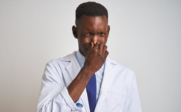 Researcher smelling arsole