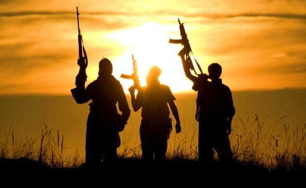 Silhouettes of armed individuals representing suspected terrorists