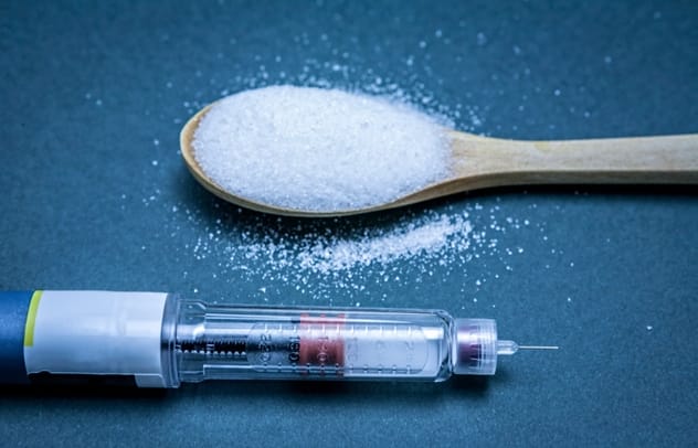 Skull and crossbones made of sugar cubes, symbolizing sugar's potential dangers