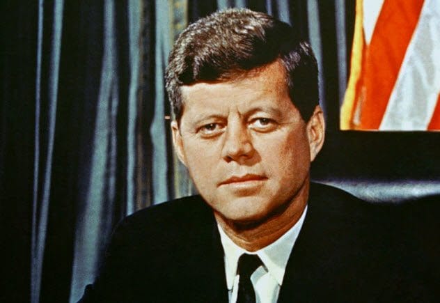 President John F. Kennedy working in the Oval Office.