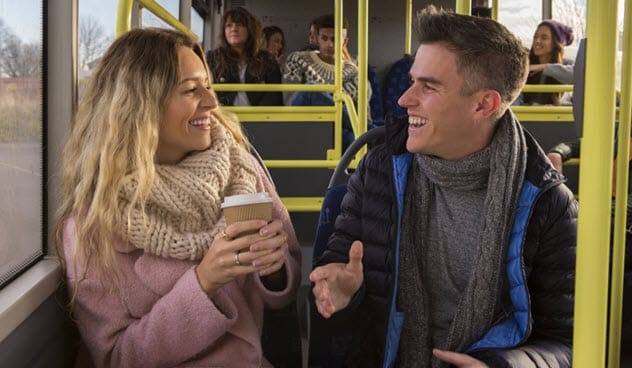 Strangers talking on a bus