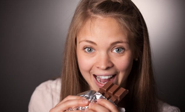 Teen eating chocolate