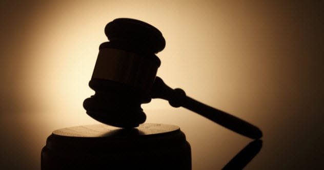 Gavel and sound block on a wooden surface, symbolizing a courtroom and testimony