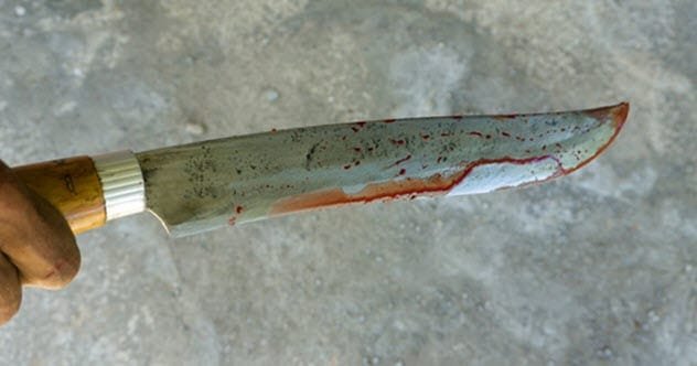 An 11-year-old boy holding a machete