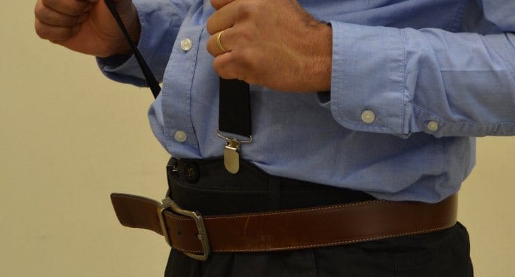 Man incorrectly wearing a belt and suspenders
