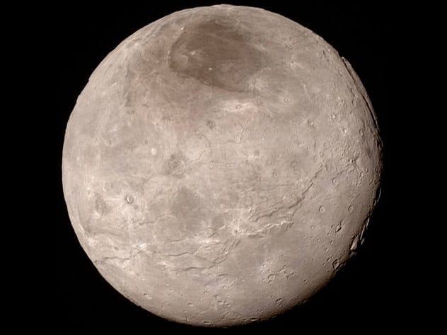 NASA image of Pluto's moon Charon showing its varied terrain and large canyons