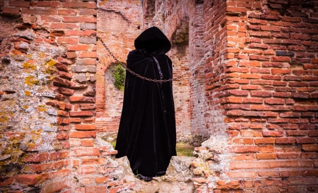 A ghostly figure in a black cloak, representing the Woman in Black