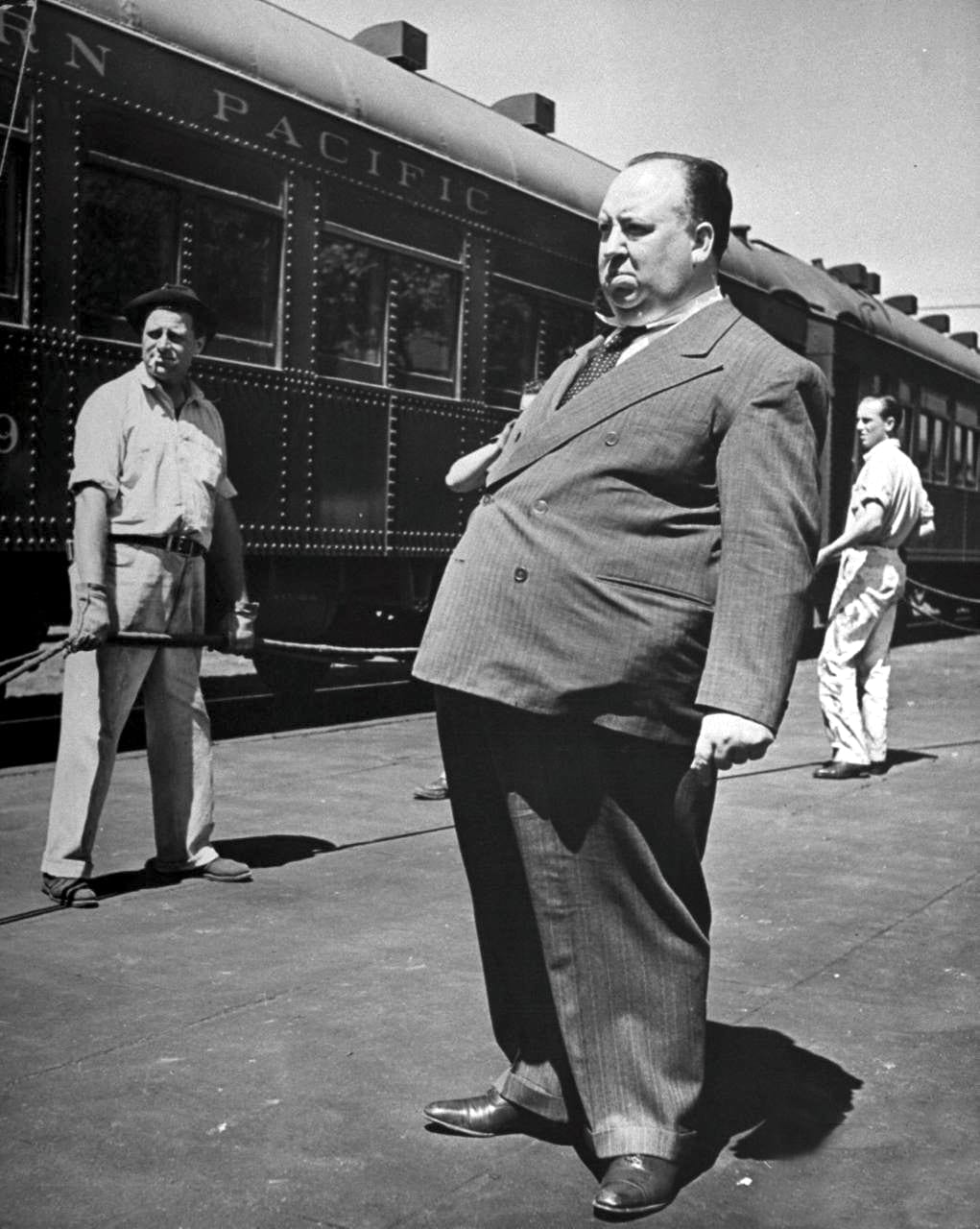 A larger-than-life photo of Alfred Hitchcock on the set of Shadow of a Doubt