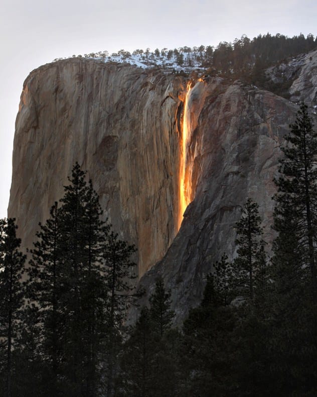 Horsetail Fall in Yosemite illuminated by the setting sun, appearing like flowing lava.