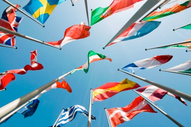 A stack of international treaty documents with a US flag, showing its treaty ratification record
