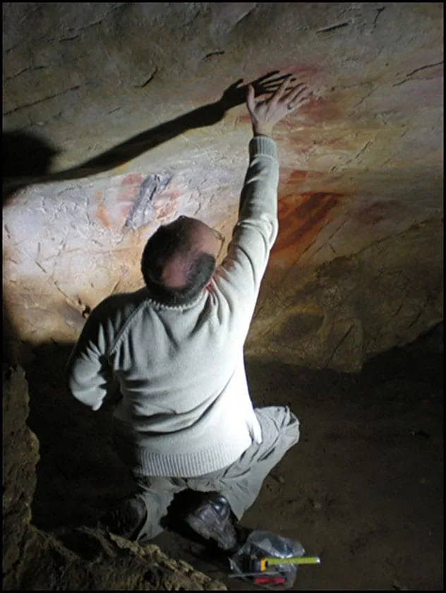 Ancient hand stencils on a cave wall