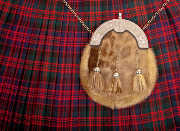 Men wearing kilts, showcasing unisex historical fashion