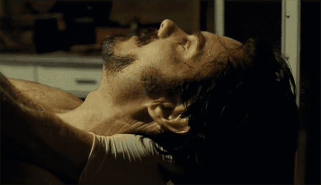 A still from The Last House on the Left showing a man's head in a microwave.