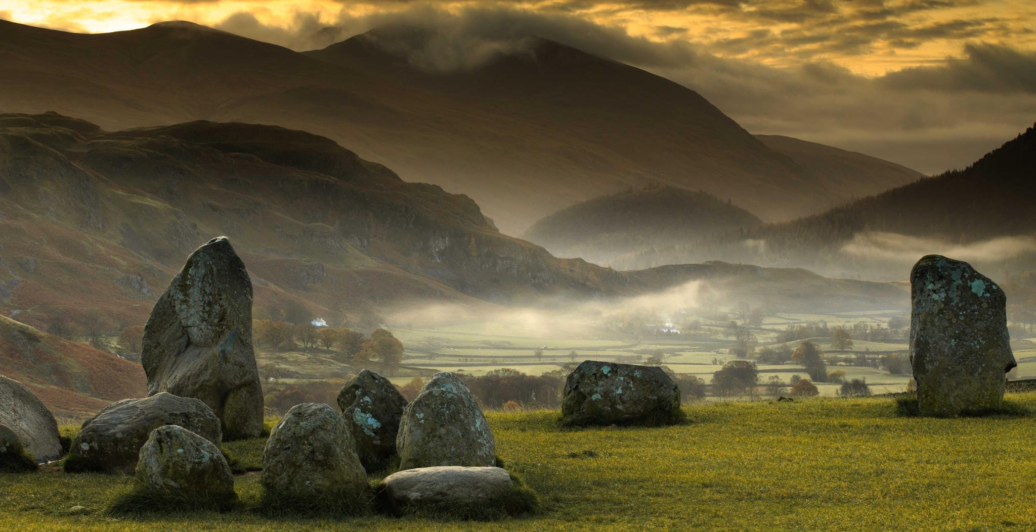 The ancient Castlerigg Stone Circle near Keswick in Cumbria, North West England, set against a dramatic mountain backdrop.