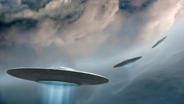 A depiction of multiple UFOs or flying discs in the sky