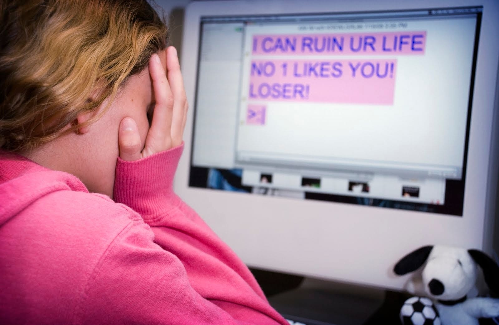 Shadowy figure representing a bully typing on a keyboard
