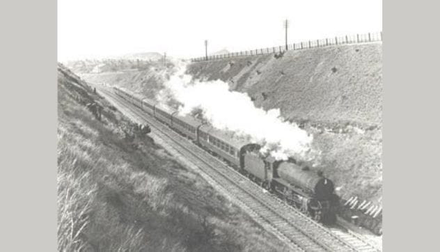 Illustration of Charles Peace's dramatic leap from a train in a desperate escape attempt.