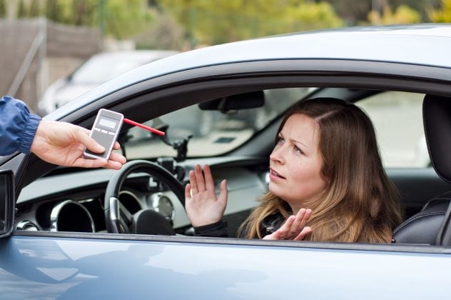 Blurred view from inside a car, representing drunk driving