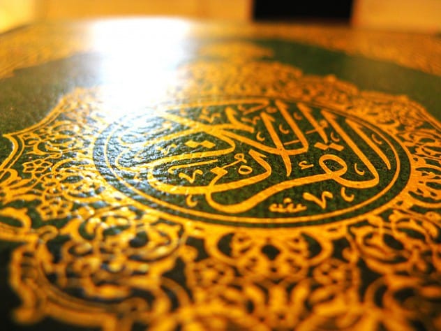 An ornate, gold-decorated Quran, representing its value