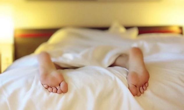 Illustration of a burglar sleeping comfortably in a bed