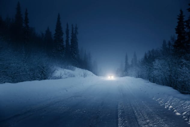 A dimly lit road at night, suggestive of a hit-and-run scene