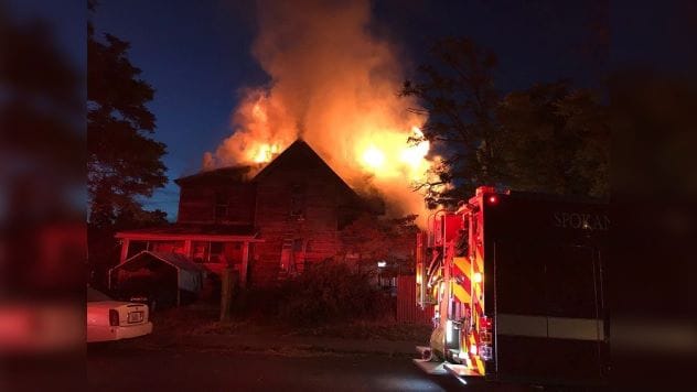 House engulfed in flames at night
