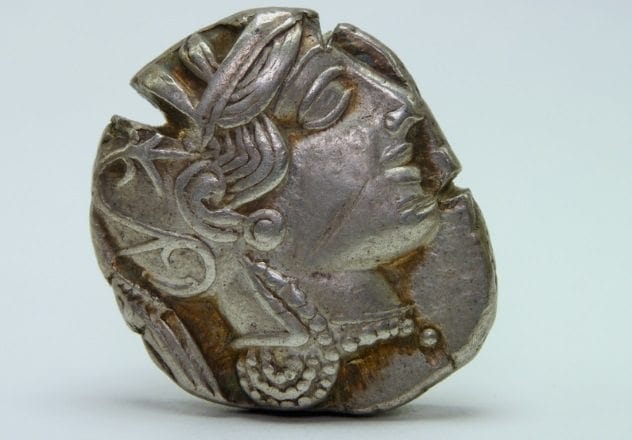 Ancient Greek coins symbolizing wealth and taxation