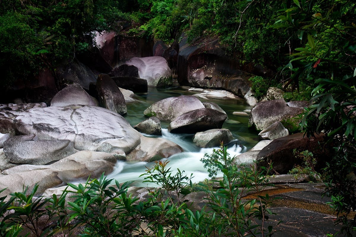 The beautiful yet treacherous Devil's Pool in Queensland, Australia, with its smooth boulders and rushing water.