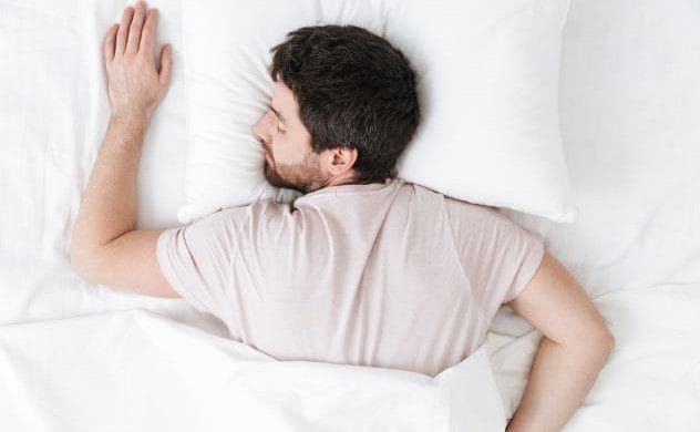 Man lying injured in a bed with concerned expression