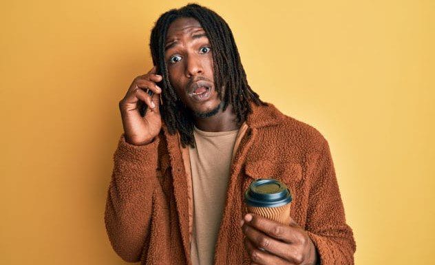 A person holding a phone, symbolizing calling ahead for a robbery