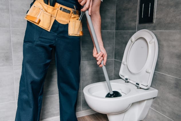 A plumber working on a pipe