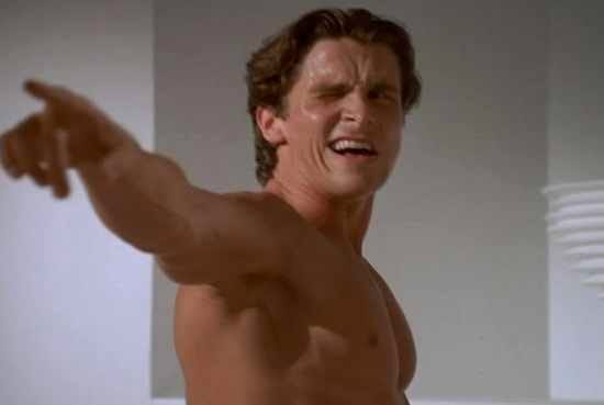 Christian Bale as Patrick Bateman in American Psycho staring into a mirror, a common trope