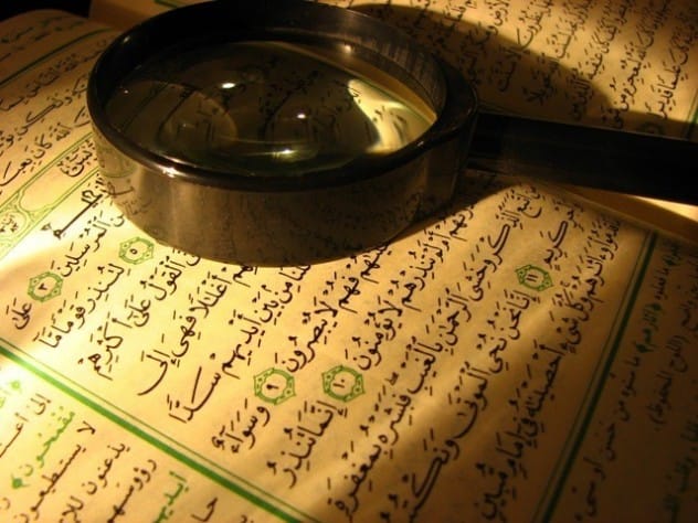 An open Quran with Arabic script