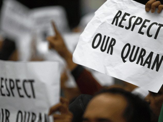 Hands respectfully holding a Quran, signifying respect