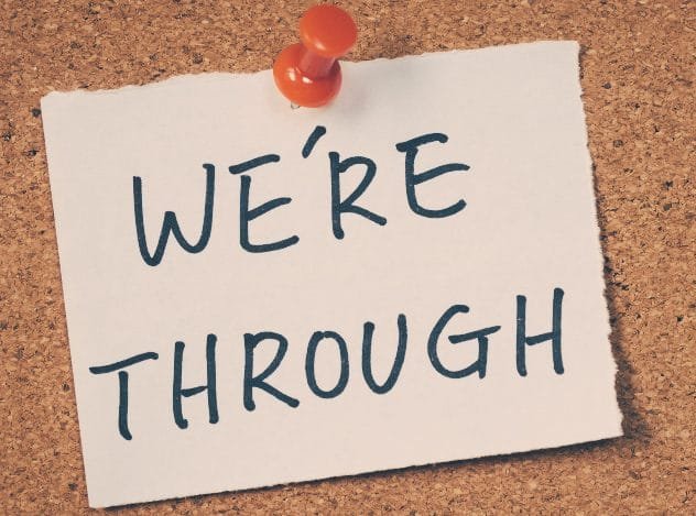 A breakup note left on a nightstand next to a bed